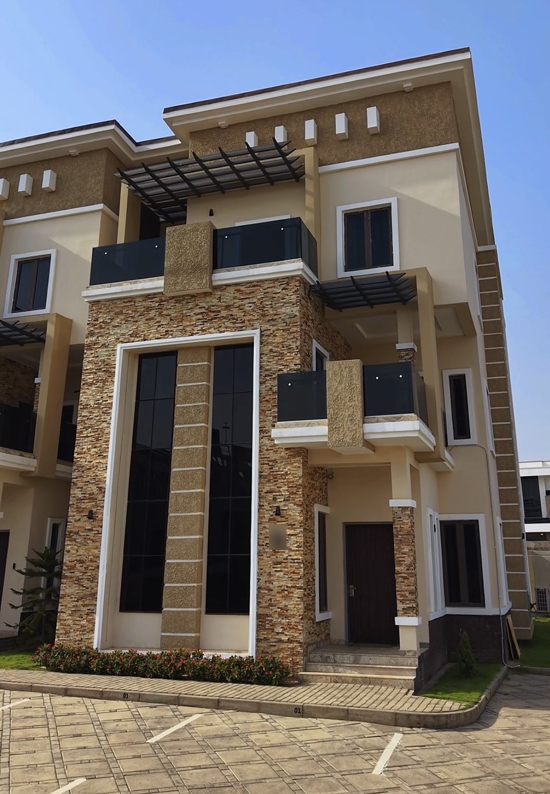 Front of a four bedroom terrace with stone cladding in Jahi, Abuja