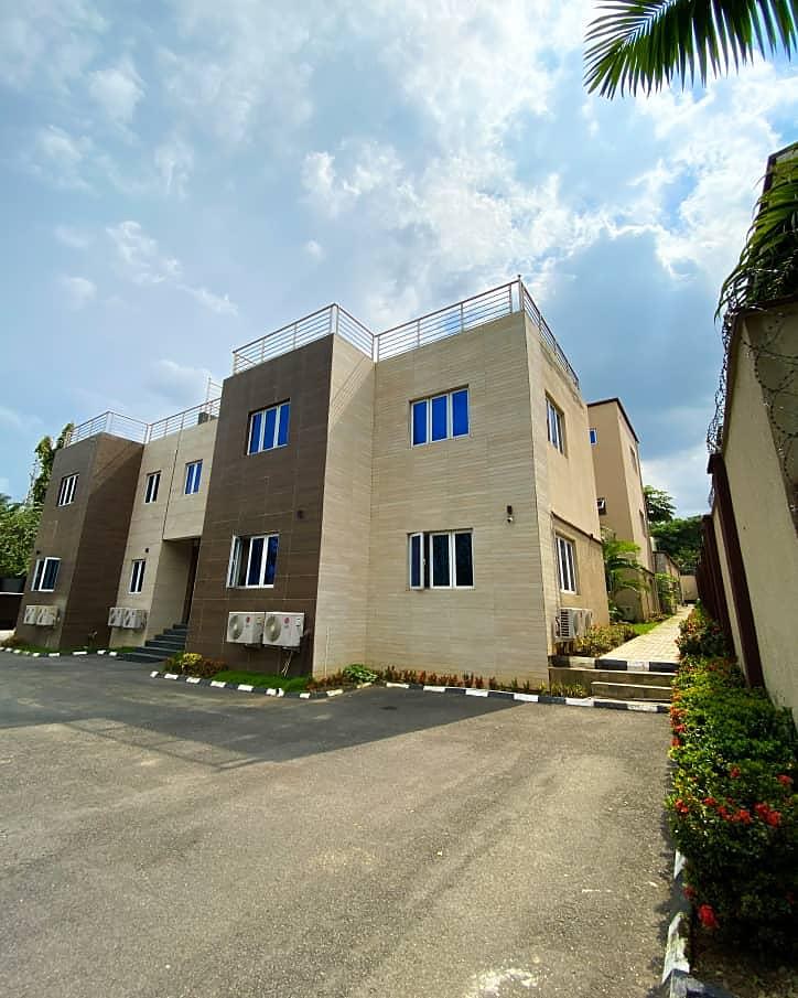 Three storey apartment block with a paved driveway in Maitama, Abuja
