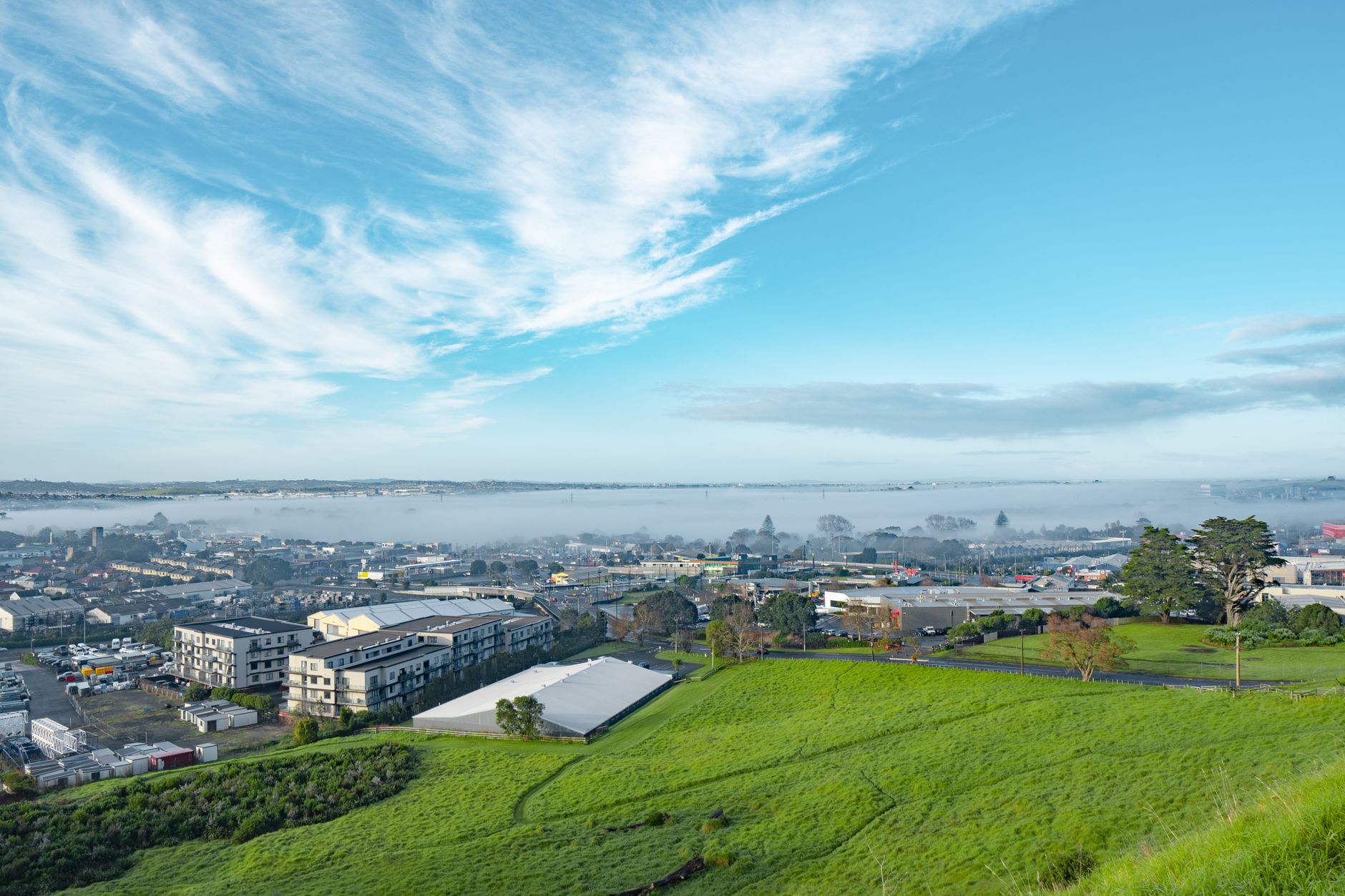 Green undeveloped land on the edge of a growing town