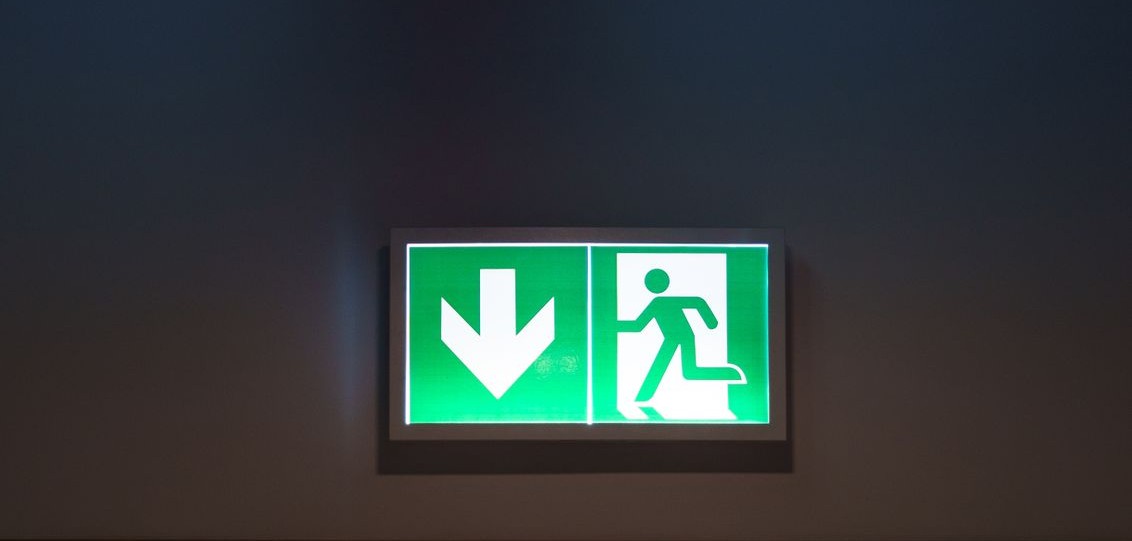 An illuminated green emergency exit sign