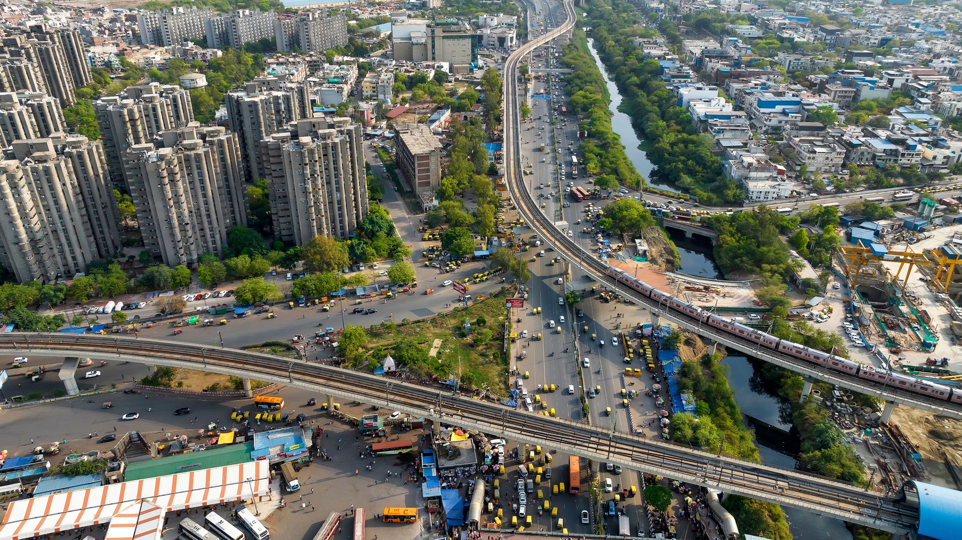 Aerial view of a dense city with highways and rail lines