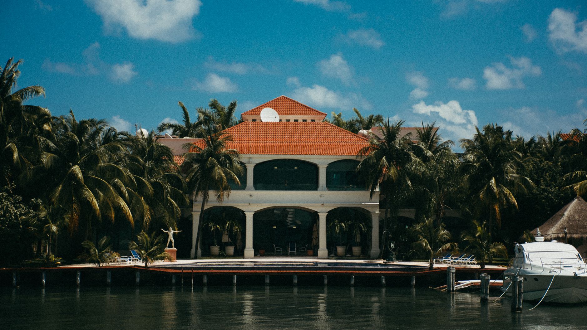 Waterfront residence framed by palm trees